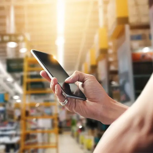 Manager onsite in a warehouse using the Workforce Client Mobile App